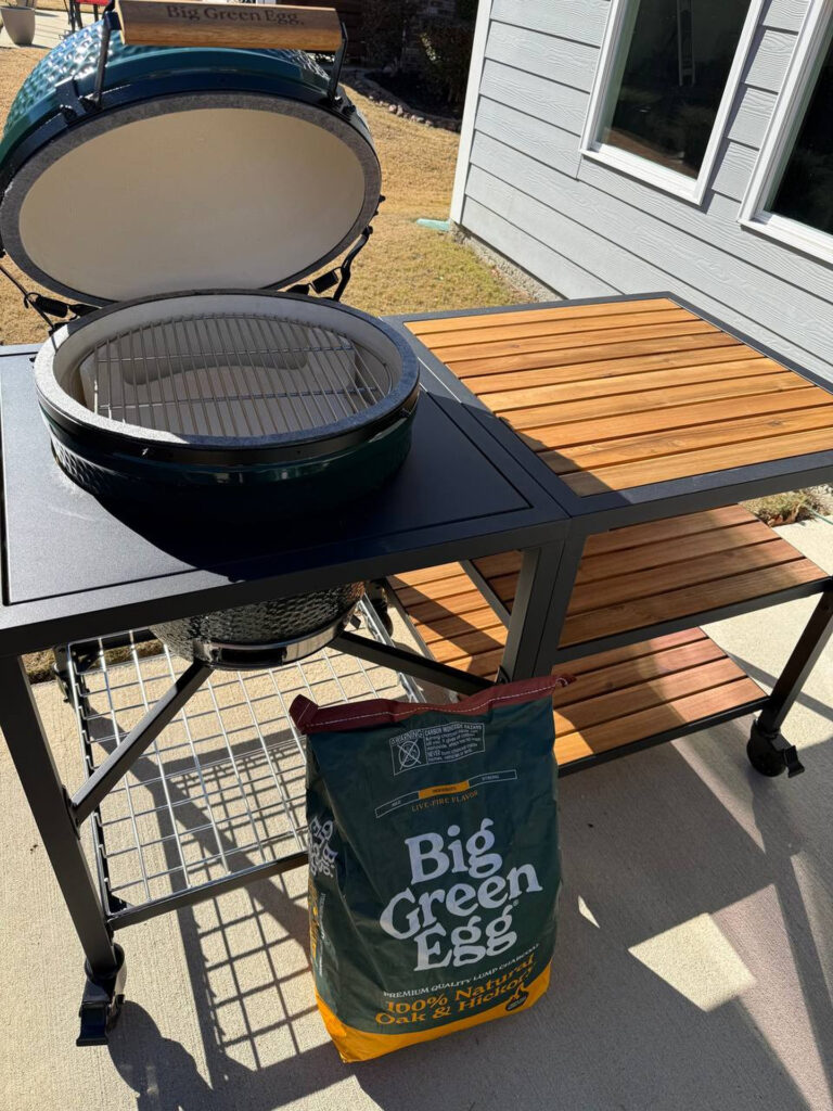 Big Green Egg in Table w- BGE Lump Charcoal on Patio